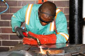 a boiler maker image welding steel pipes.